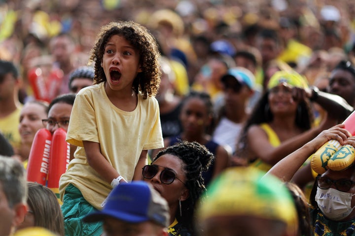 Soccer Football - FIFA World Cup Qatar 2022 - Fans in Brazil watch Brazil v Serbia - Rio de Janeiro, Brazil - November 24, 2022 A young Brazil fans reacts as they watch the match at the FIFA Fan Festival on the Copacabana beach REUTERS/Ricardo Moraes