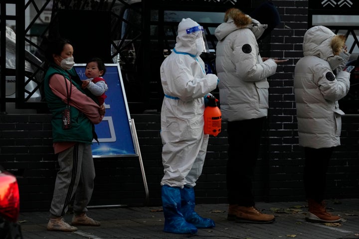 Residents line up for COVID-19 tests in Beijing, Saturday, Nov. 26, 2022.