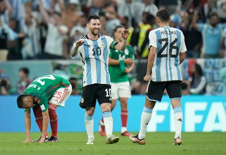 Argentina's Lionel Messi celebrates with Nahuel Molina after their team won the World Cup group C soccer match between Argentina and Mexico, at the Lusail Stadium in Lusail, Qatar, Saturday, Nov. 26, 2022. (AP Photo/Hassan Ammar)