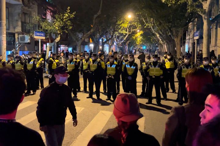 Chinese police officers block off access to a site where protesters had gathered in Shanghai on Sunday, Nov. 27, 2022. Protests against China's strict "zero-COVID" policies resurfaced in Shanghai and Beijing on Sunday afternoon, continuing a round of demonstrations that have spread across the country since a deadly apartment fire in the northwestern city of Urumqi led to questions over such rigid anti-virus measures. (AP Photo)