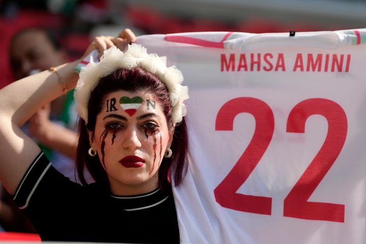 Daily News A woman shows a soccer shirt in memory of 22-year-old Mahsa Amini prior to the World Cup group B soccer match between Wales and Iran on Friday in Qatar.