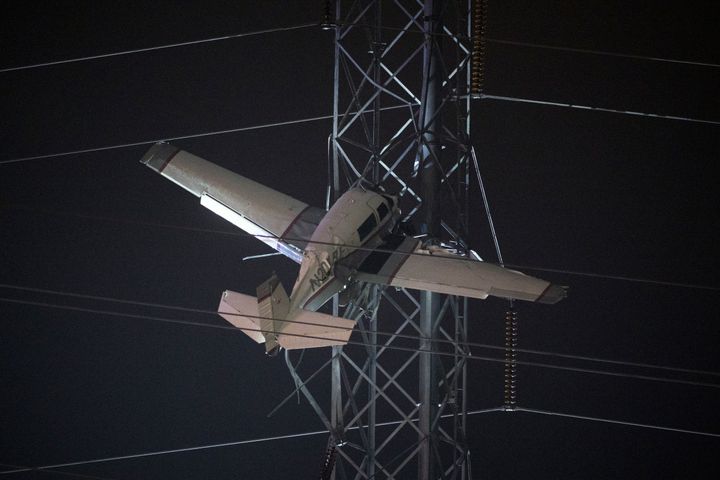 A small plane rests on live power lines after crashing on Nov. 27, 2022, in Montgomery Village, a northern suburb of Gaithersburg, Md. 