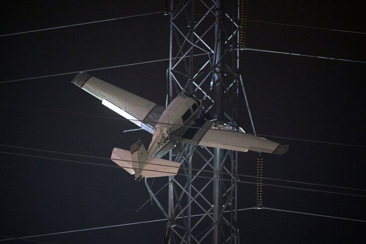 A small plane rests on live power lines after crashing on Nov. 27, 2022, in Montgomery Village, a northern suburb of Gaithersburg, Md.