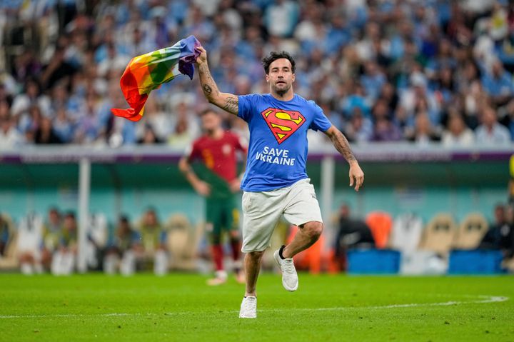 A protester with a rainbow flag on the pitch during the FIFA World Cup Qatar match between Portugal and Uruguay.