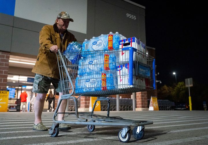 John Beezley of Bonham, Texas, carts out several cases of water after learning that a boil water notice was issued for the entire city of Houston on Sunday.