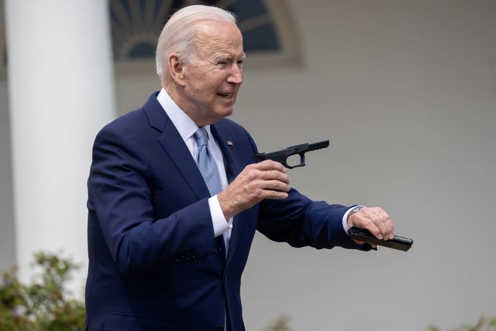 President Joe Biden interacts with a ghost gun during an event on gun violence held in the Rose Garden at the White House on April 11.