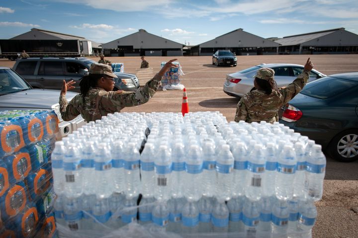 Mississippi National Guard members direct traffic at a water distribution site at the Mississippi State Fairgrounds in Jackson in September. 