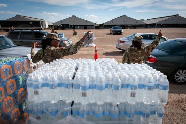 Mississippi National Guard members direct traffic at a water distribution site at the Mississippi State Fairgrounds in Jackson in September.