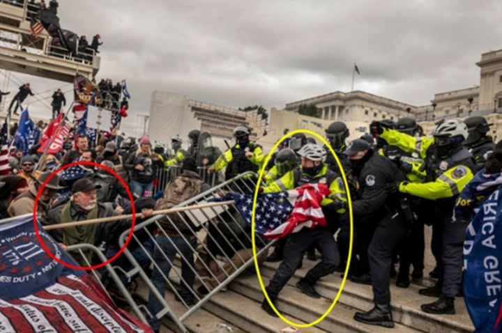 A man identified by federal law enforcement as Dale Huttle is seen holding a flag pole during a scuffle with officers outside the U.S. Capitol in Jan. 2021.