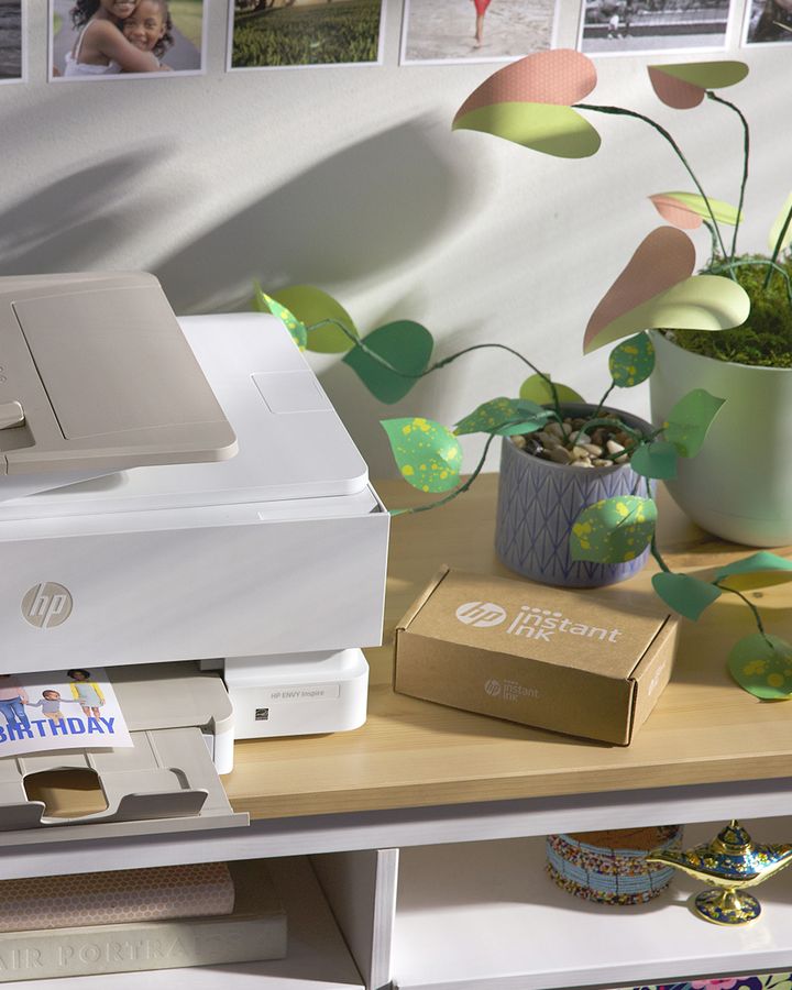 An HP box set beside a printer