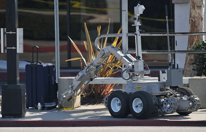 A Long Beach, Calif., police robot inspects a suspicious package at a bus stop on Ximeno Ave. just north of Pacific Coast Highway on Jan. 27, 2010. San Francisco police currently have a dozen functioning ground robots used to assess bombs or provide eyes in low visibility situations.