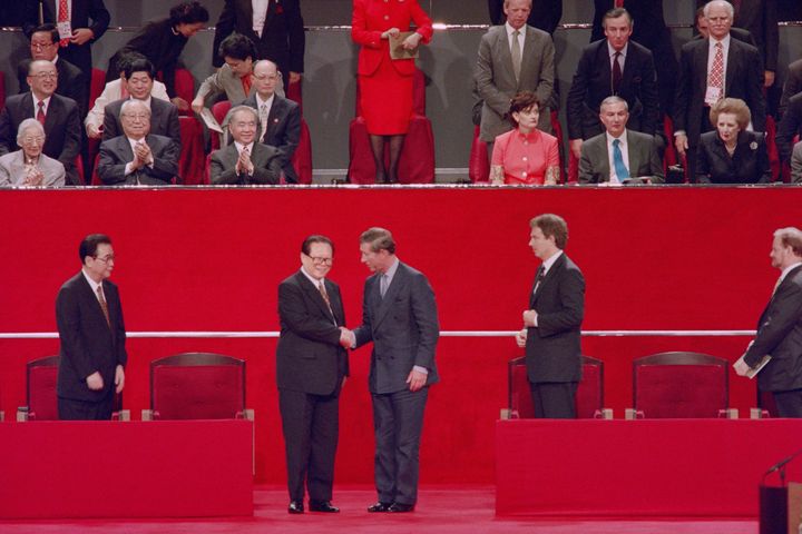 Chinese President Jiang Zemin, left, shakes hands with Prince Charles during the handover ceremony on July 1, 1997, in Hong Kong. 