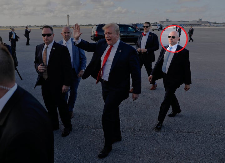 Then-President Donald Trump, center, surrounded by members of the Secret Service, including Tony Ornato, right, walks across the tarmac to begin to greet supporters during his arrival at Palm Beach International Airport, in West Palm Beach, Fla., on April 18, 2019.