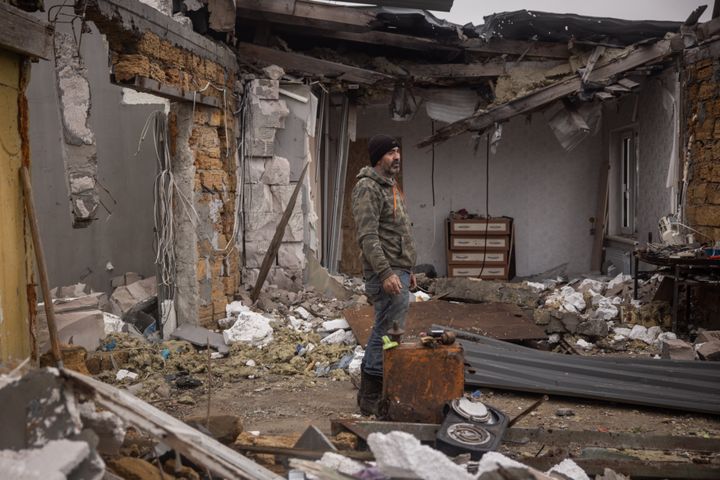 Serhiy Siryi stands amid his destroyed house as he works to cleanup debris in the village of Posad Pokrovske on the outskirts of Kherson.