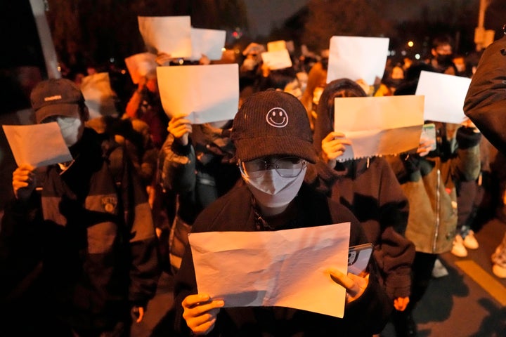 Protesters hold up blank papers and chant slogans as they march in protest in Beijing, on Nov. 27, 2022. In a society where everything is closely monitored and censored, the white paper is a silent protest against users not being allowed to speak.