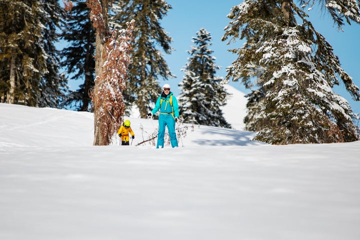 Mother and son skiing in mountains