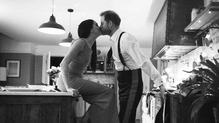 Duke and Duchess of Sussex kissing in a kitchen in a trailer for a new documentary called Harry & Meghan.