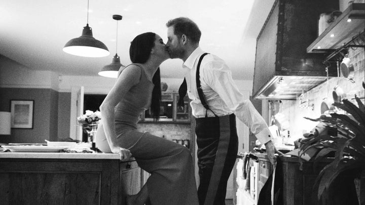 Duke and Duchess of Sussex kissing in a kitchen in a trailer for a new documentary called Harry & Meghan.