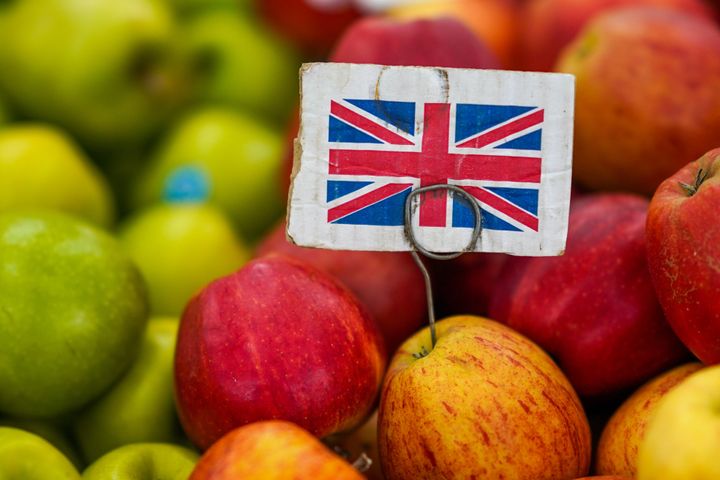 A British Union flag on a heap of apples for sale. Photographer: Ian Forsyth/Bloomberg