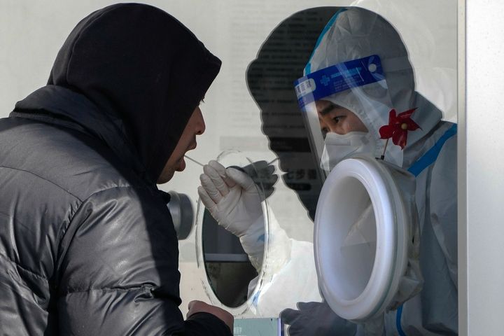 A man undergoes a routine COVID-19 test Nov. 29 at a site in Beijing. Chinese universities had been sending students home as the ruling Communist Party tightened coronavirus controls and tried to prevent more protests over "zero COVID" restrictions and calls for President Xi Jinping to resign.