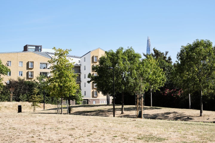 UK, London, Southwark, park view of modern residential buildings with view of the Shard in distant