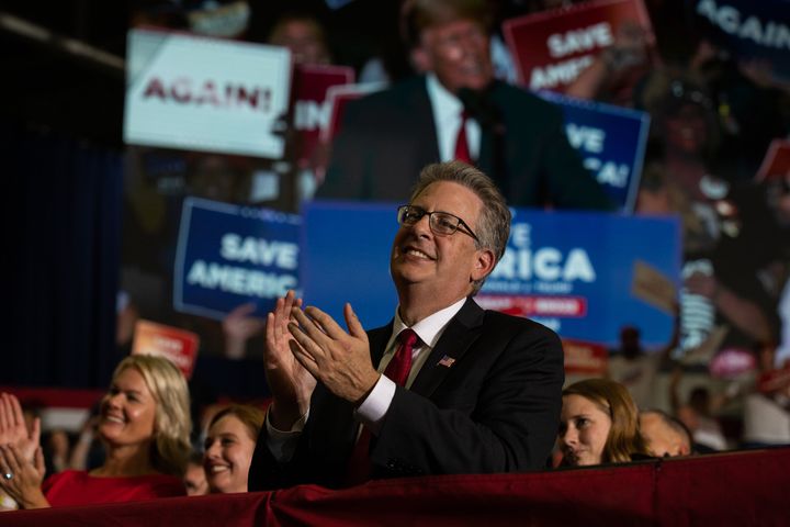 Republican candidate for attorney general Matthew DePerno claps during former President Donald Trump's remarks during a Save America rally on Oct. 1 in Warren, Michigan.