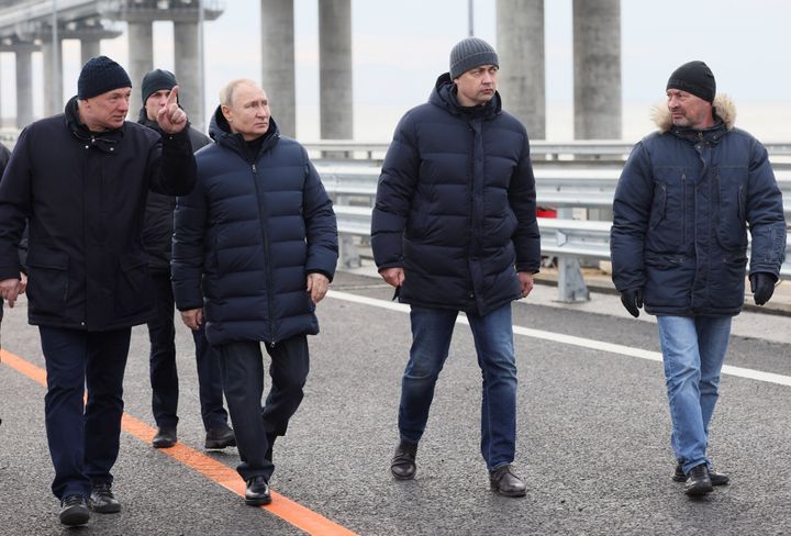 Ο Ρώσος Πρόεδρος Βλαντιμίρ Πούτιν ακούει τον αντιπρόεδρο της κυβέρνησης Mαράτ Χουσνούλιν καθώς επισκέπτεται μια γέφυρα που συνδέει τη ρωσική ηπειρωτική χώρα με τη χερσόνησο της Κριμαίας μέσω του πορθμού Kερτς, 5 Δεκεμβρίου 2022.