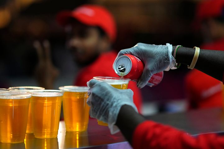 A staff member pours a beer at a fan zone ahead of the FIFA World Cup in Qatar.