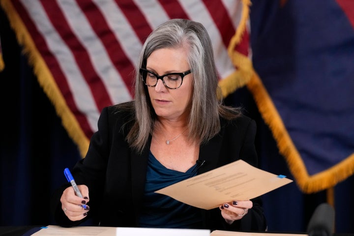 Katie Hobbs, the Democratic governor-elect and current secretary of state, signs the official certification for the Arizona general election canvass during a ceremony at the Arizona Capitol in Phoenix, on Dec. 5, 2022.