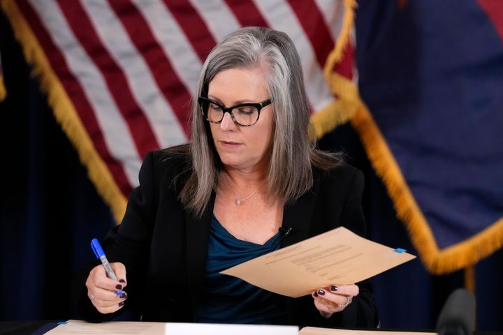 Katie Hobbs, the Democratic governor-elect and current secretary of state, signs the official certification for the Arizona general election canvass during a ceremony at the Arizona Capitol in Phoenix, on Dec. 5, 2022. 