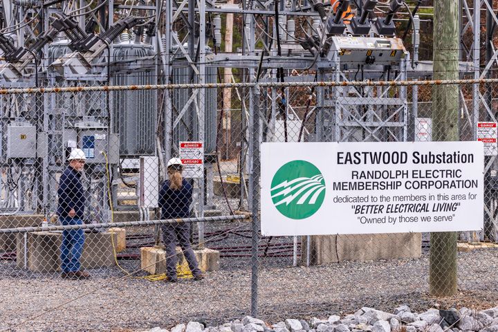 Workers with Randolph Electric Membership Corporation work to repair the Eastwood Substation in West End, North Carolina.