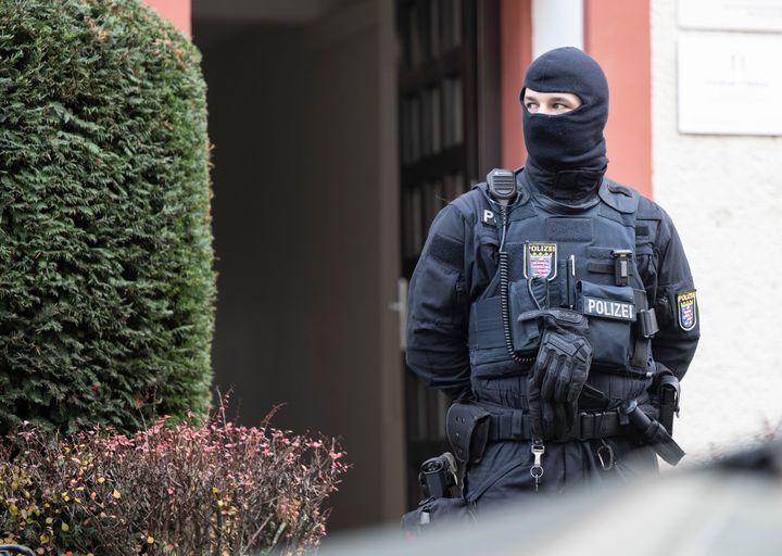 Police officers stand by a searched property in Frankfurt during a raid against so-called 'Reich citizens' in Frankfurt, Germany, on Dec. 7, 2022. Thousands of police carried out a series of raids across much of Germany on Wednesday against suspected far-right extremists who allegedly sought to overthrow the state by force.
