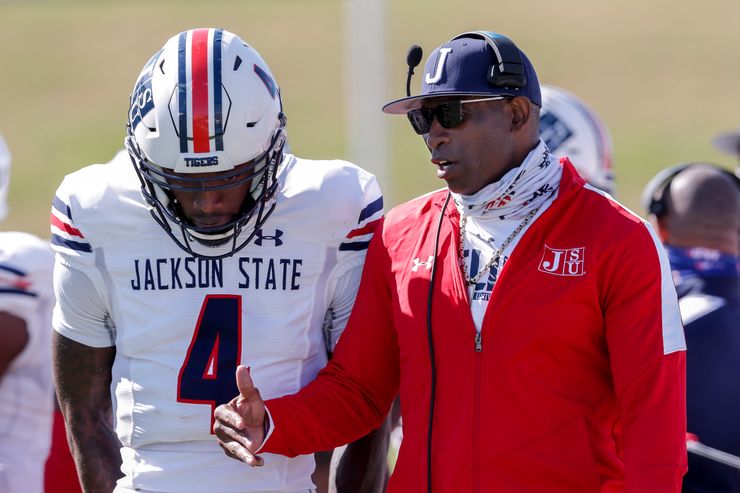 Head coach Deion Sanders talks with Jackson State quarterback Jalon Jones in a game against the Alabama State Hornets on March 20, 2021, in Montgomery, Alabama. 