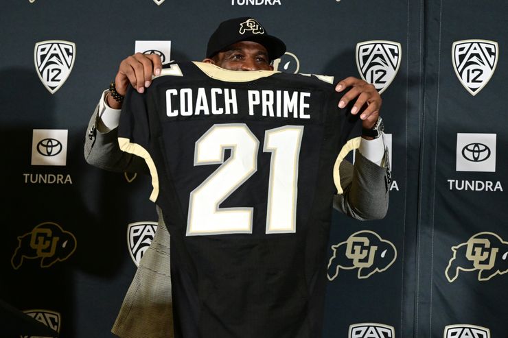 Sanders holds up a personalized University of Colorado jersey during a press conference on Dec. 4, 2022, in Boulder, Colorado, after being announced as the school's new head football coach. 
