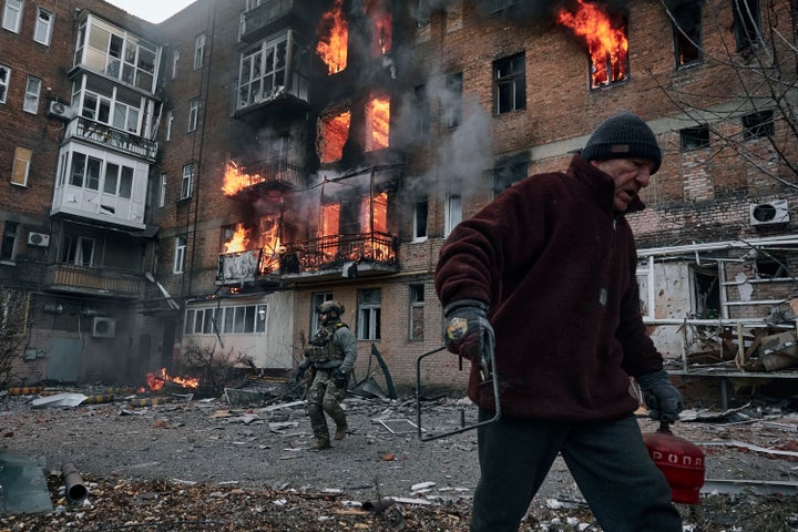 A local resident leaves his home after Russian shelling destroyed an apartment house in Bakhmut, Donetsk region, Ukraine, on Dec. 7, 2022.