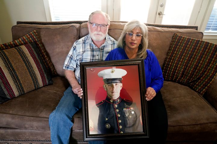 Joey and Paula Reed pose for a photo with a portrait of their son Marine veteran and then-Russian prisoner Trevor Reed at their Texas home in February of 2022. Reed was released as part of a prisoner exchange two months later