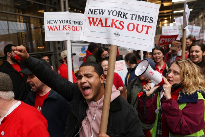 Protesters gathered with signs saying "NEW YORK TIMES WALKS OUT."