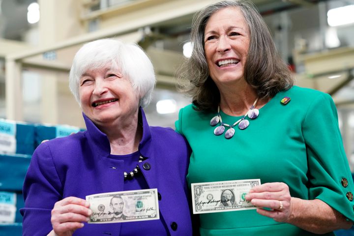 Treasury Secretary Janet Yellen and U.S. Treasurer Lynn Malerba hold up newly minted $5 bills signed for the first time ever by two women.