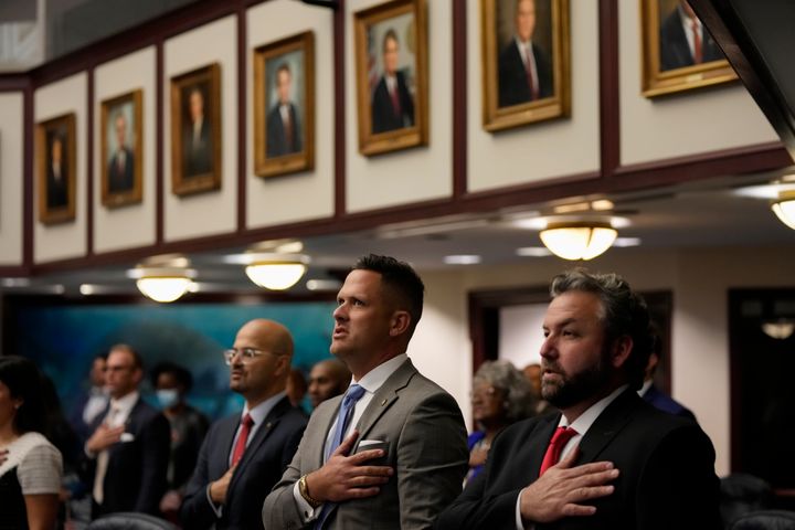 R to L: Florida state congressmen Adam Botana, Joe Harding and Tom Fabricio recite the Pledge of Allegiance during the opening of a special legislative session targeting COVID-19 vaccine mandates on Nov. 15, 2021, at the state Capitol in Tallahassee.