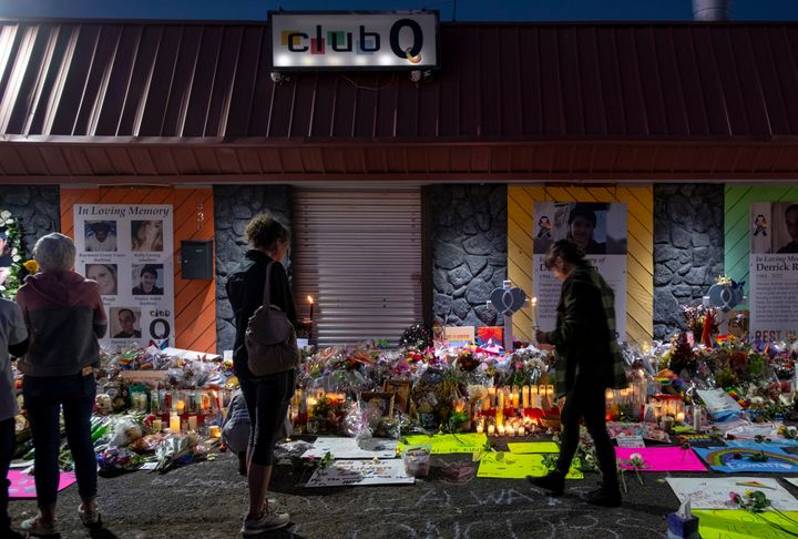 Mourners gather at a memorial outside Club Q, which has been moved from a sidewalk outside of police tape that was surrounding the club on Nov. 25 in Colorado Springs, Colorado.