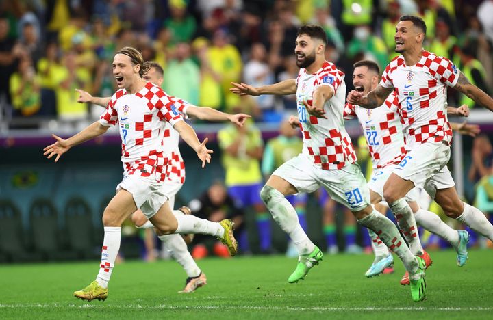 Soccer Football - FIFA World Cup Qatar 2022 - Quarter Final - Croatia v Brazil - Education City Stadium, Doha, Qatar - December 9, 2022 Croatia's Lovro Majer, Josko Gvardiol and Dejan Lovren celebrate winning the penalty shootout REUTERS/Hannah Mckay