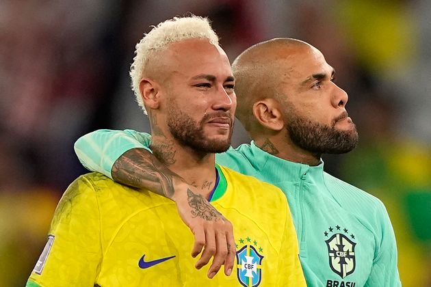 Brazil's Neymar, left, has tears in his face beside Brazil's Dani Alves, right, after losing the World Cup quarter-final.