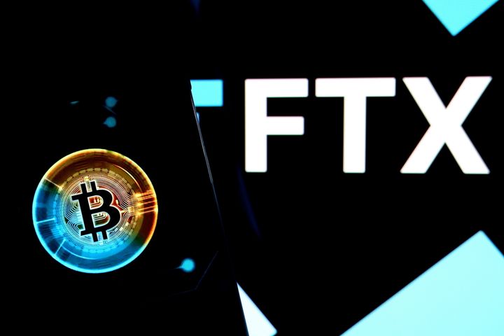 A bitcoin logo seen displayed on a smartphone with a FTX logo on the background. A campaign finance watchdog has accused Sam Bankman-Fried, the ex-CEO of FTX, of using dark money groups to conceal millions in campaign donations to Republicans during the 2022 primary campaign.