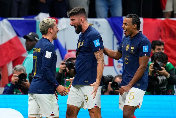 France's Olivier Giroud, centre, celebrates with teammate's Antoine Griezmann, left, Jules Kounde after scoring his team's second goal during the World Cup quarterfinal soccer match between England and France, at the Al Bayt Stadium in Al Khor, Qatar, Saturday, Dec. 10, 2022. (AP Photo/Natacha Pisarenko)