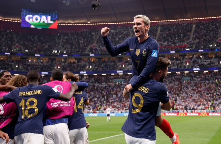 Dec 10, 2022; Al Khor, Qatar; France forward Olivier Giroud (9) celebrates with forward Antoine Griezmann (7) and teammates after scoring during the second half of a quarterfinal game against England in the 2022 FIFA World Cup at Al-Bayt Stadium. Mandatory Credit: Yukihito Taguchi-USA TODAY Sports