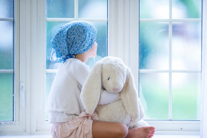 Young oncology patient wears a bandana headscarf.