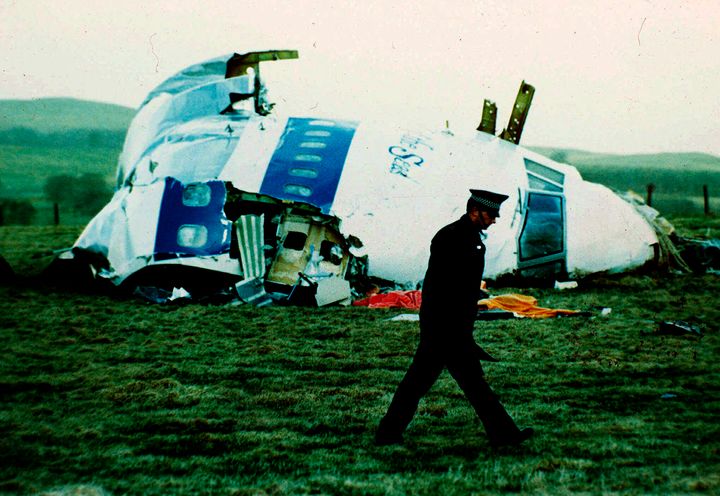 A police officer walks by the nose of Pan Am flight 103 in a field near the town of Lockerbie, Scotland after a bomb exploded on board, killing a total of 270 people on Dec. 21, 1988.