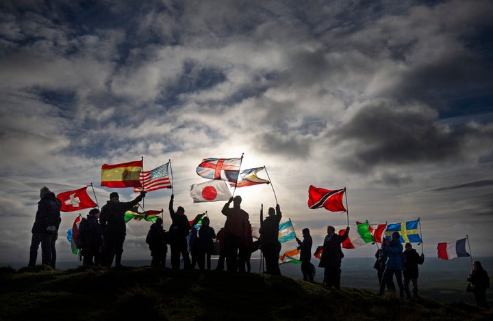 Residents of Lockerbie and others affected by the 1988 bombing climb Burnswark Hill in Dumfries and Galloway with 21 flags, representing the 21 nationalities of the victims, to commemorate the 30th anniversary of the air disaster in 2018.