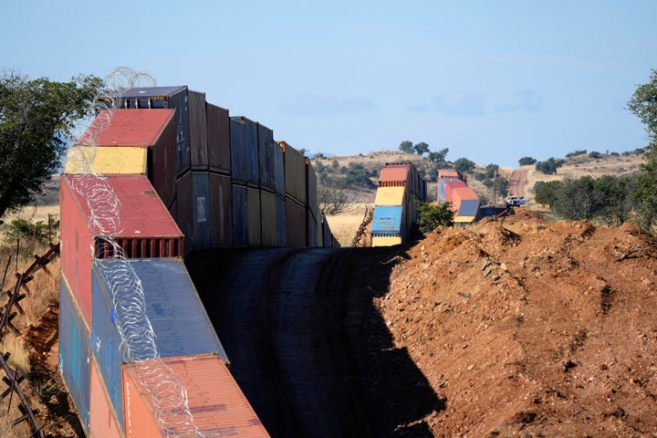 A long row of double-stacked shipping contrainers provide a new wall between the United States and Mexico in the remote section area of San Rafael Valley, Ariz. 