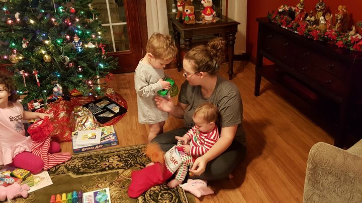 The author and her kids celebrating Christmas at her mom's house in 2016. “My kids were 4, 2, and 8 months old,” she writes. “My mom's new nativity scene is decorating the background.”